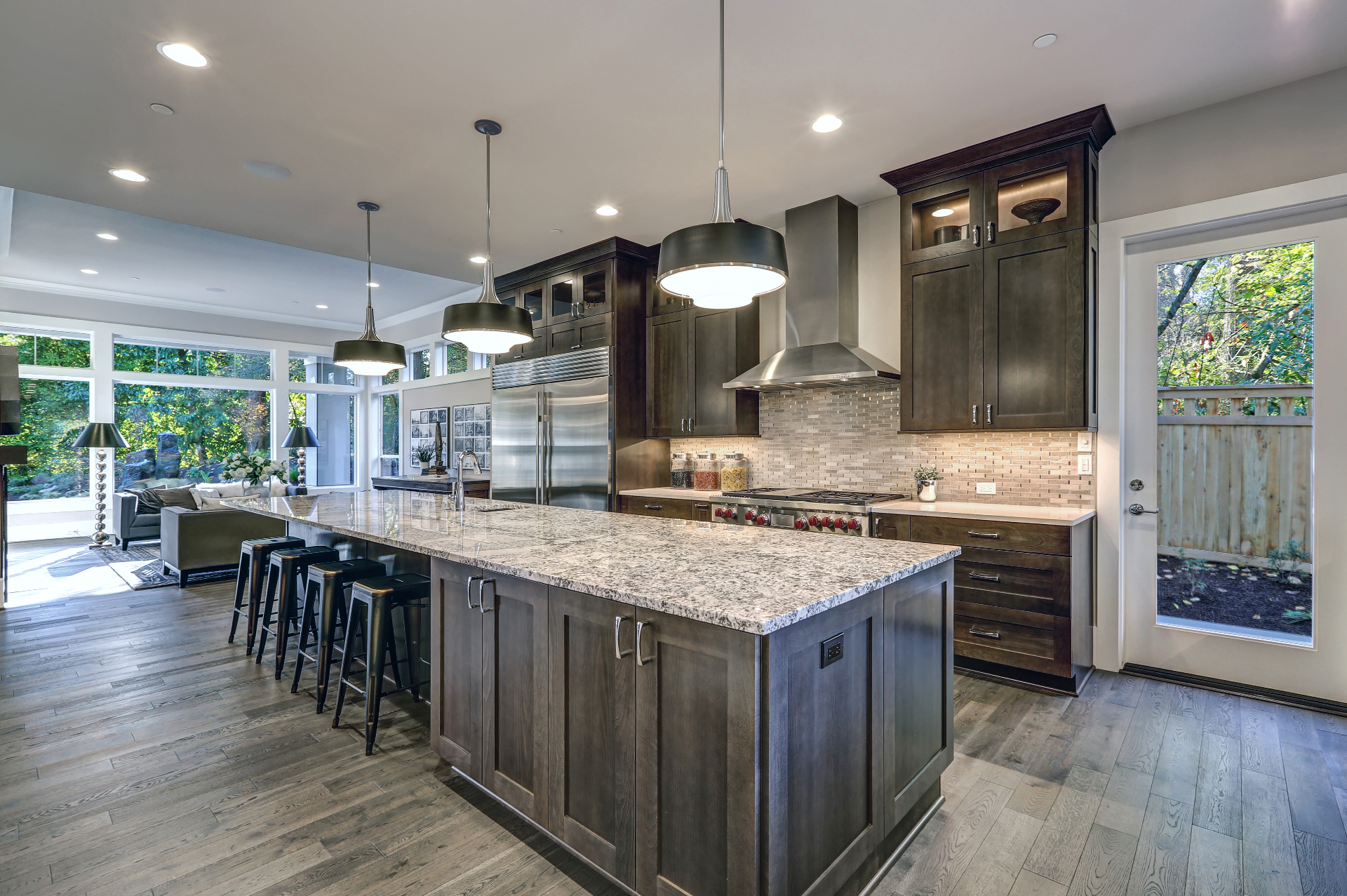 Luxury white kitchen remodel with marble island, custom cabinetry, and pendant lighting by Icon Remodeling